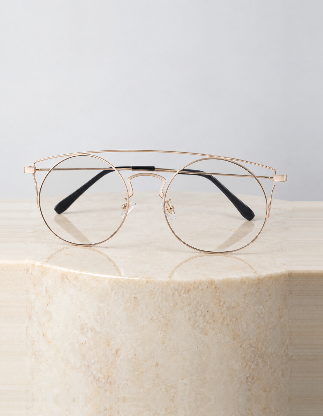 Ara Clear sunglasses on a round cream marble plinth