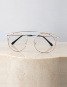 Ara Clear sunglasses on a round cream marble plinth