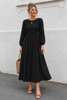 Women's black long sleeve cotton midi dress with smocked bodice, the Iolana Dress in Black Long Sleeve by Esther & Co