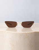 Otto Brown Sunglasses on a round cream marble plinth