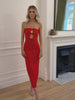 Elegant woman in a red strapless evening gown, perfect for weddings, formal events, balls, galas, and special occasions, standing in a sophisticated room with wooden flooring and a fireplace.