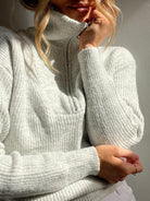 Women wearing the Merete Knit in Grey, a classic women's jumper with high collar and zip detail