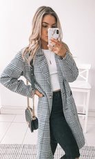 Side view of the Polaris Coat in Print showing the structured silhouette and long sleeves