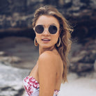 Black frame sunglasses with dark lenses, the Catalina Sunglasses in Black by Esther & Co