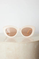 Beige cat-eye sunglasses with dark lenses, the Banks Sunglasses in Beige by Esther & Co