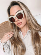 A pair of sunglasses with green frames and brown lenses displayed on a surface.