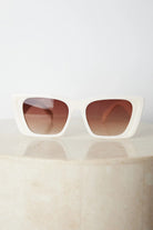 Beige frame sunglasses with dark lenses, the Calloway Sunglasses in Beige by Esther & Co