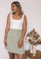 Women's sage fitted mini skirt with front pockets by Esther & Co